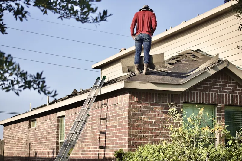 Professional roofer working on a residential roof in Oak Terrace